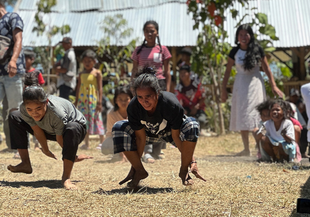 Embracing heritage and culture, the community comes together to play a traditional game that has been passed down through generations.