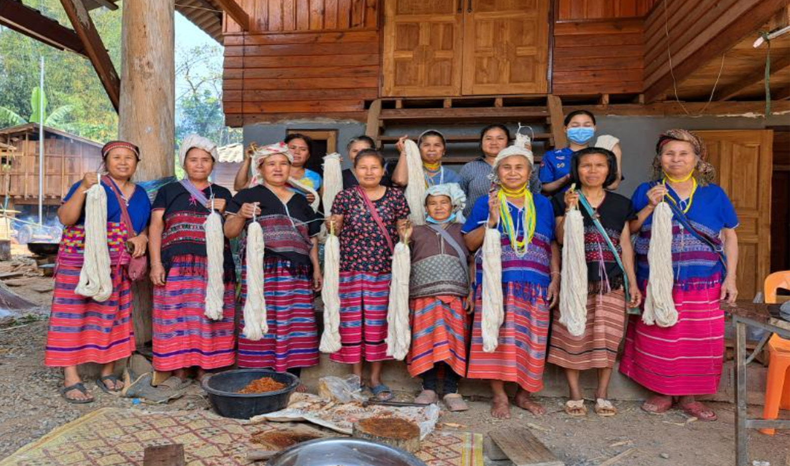 Women group with yarns, and tree barks for dying